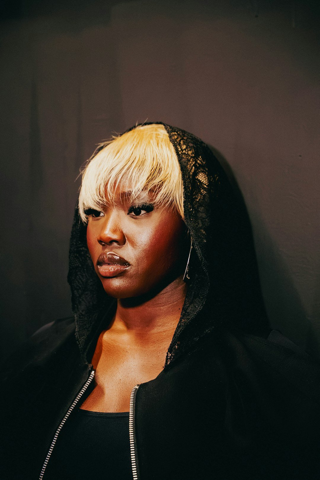 Editorial portrait in a black lace hood